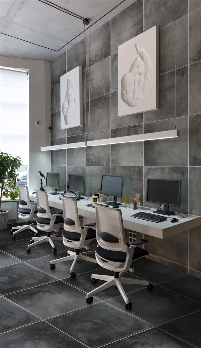 postmodern Hot-desk Region decorated with art work and concrete look tiles.jpg