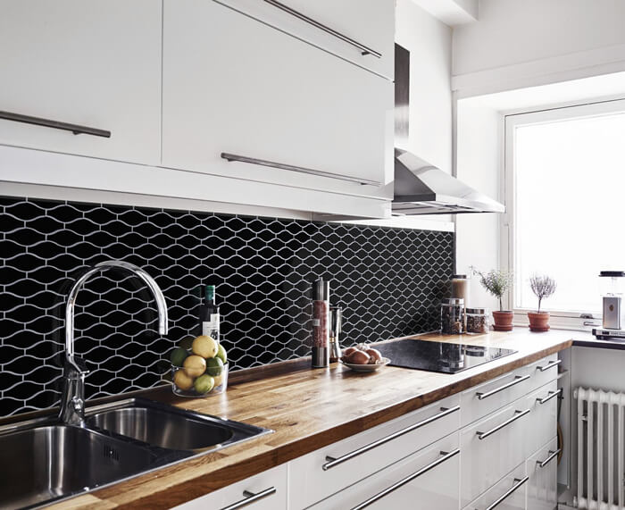 kitchen design using black mosaic wall tiles.jpg