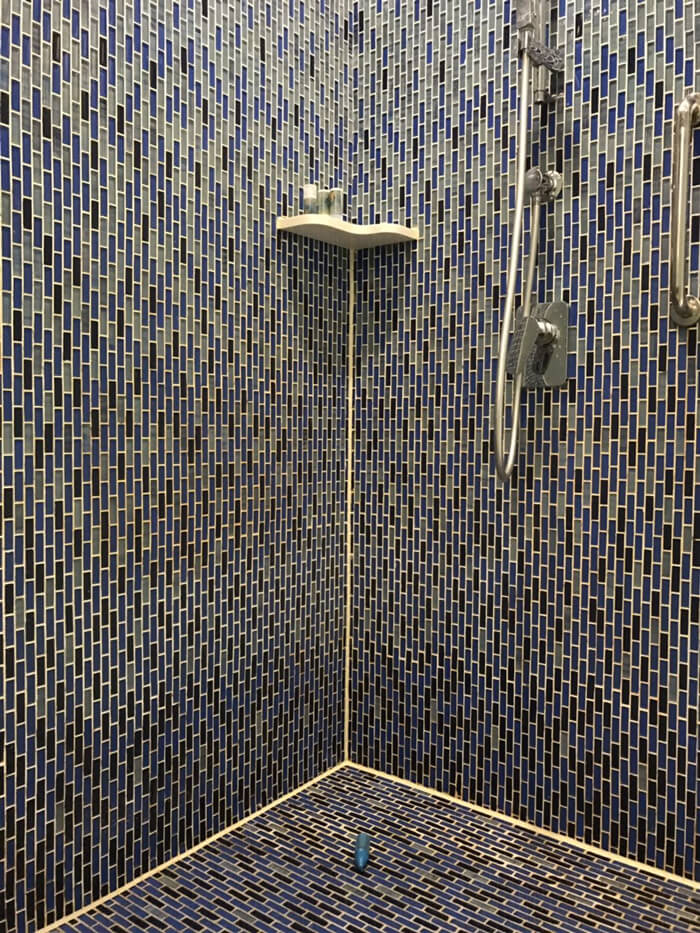 hotel shower using glass mosaic tile floor.jpg