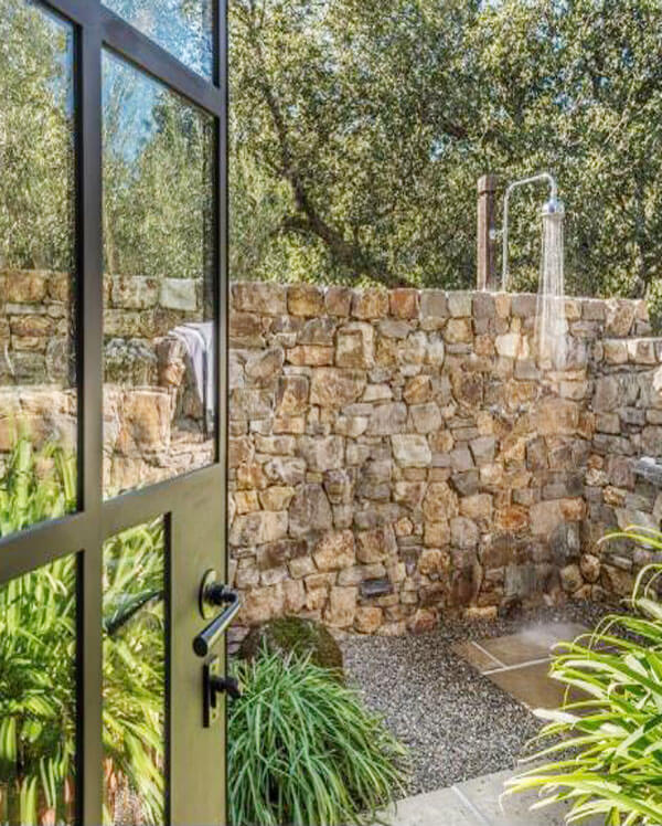 exterior stacked stone surrounding the outdoor shower