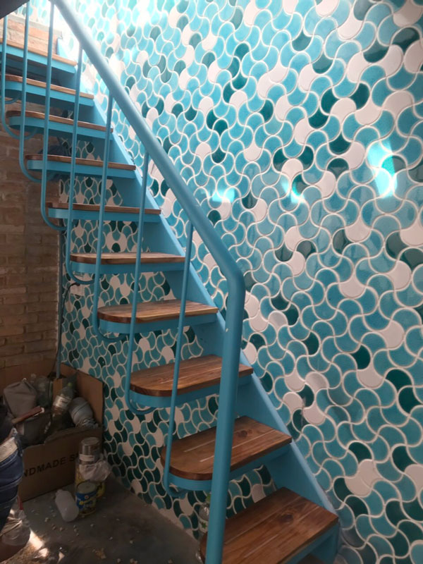 the stair background walls are mixed mosaic tiles